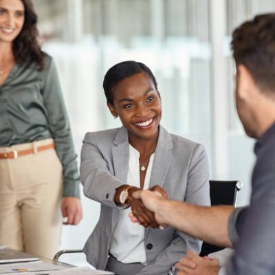 istockphoto-1413759521-612x612 Happy black businesswoman and businessman shaking hands at meeting. Professional business executive leaders making handshake agreement. Happy business man closing deal at negotiations with african american woman.